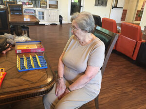 Senior woman playing board game